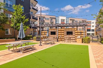 A small grassy area with a picnic table and a shade umbrella. at Bridge at Henley, Austin